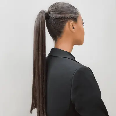 model with a slick ponytail and braids on the side