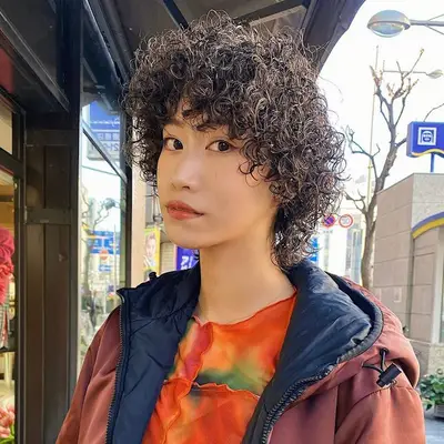 woman with curly hair on white background
