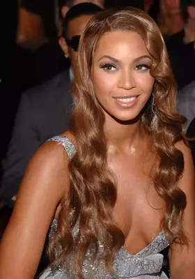 Beyonce with face-framing straight platinum blonde hair.