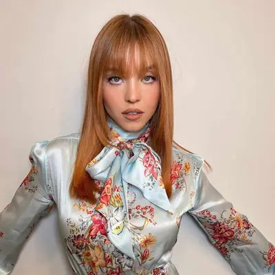 Red hair with long face-framing layers and long fringe