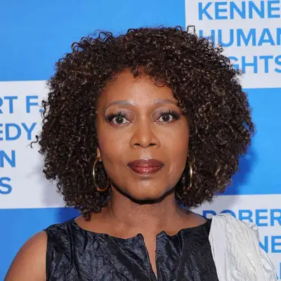 Alfre Woodard wears a tapered bob hairstyle with defined natural coils