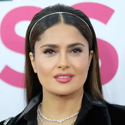 Salma Hayek wears a straight medium-length hairstyle with a gemstone headband