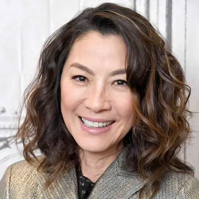 Michelle Yeoh wears a wavy long bob hairstyle with highlights and lowlights