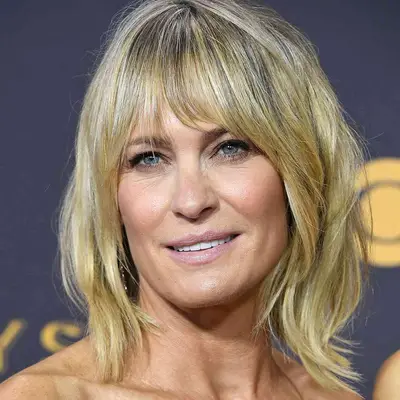 Robin Wright wears a piecey long bob hairstyle with parted bangs