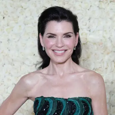 Julianna Margulies wears a brushed-back, voluminous shoulder-length hairstyle