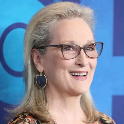 Meryl Streep wears a voluminous slicked-back long bob hairstyle with flipped ends
