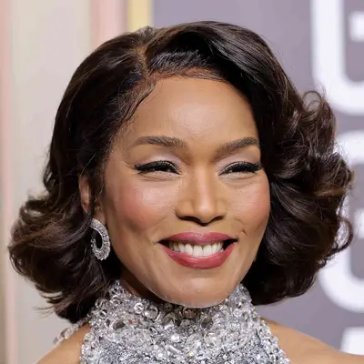 Angela Bassett wears a feathered bob hairstyle in old Hollywood curls