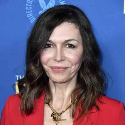 Finola Hughes wears a side-parted shoulder-length hairstyle with tousled waves