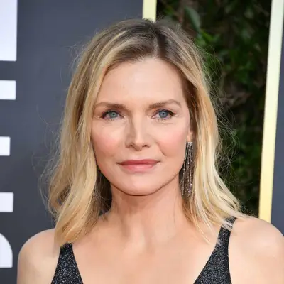 Michelle Pfeiffer wears a long bob hairstyle with tousled wispy layers