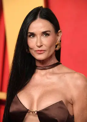 Demi Moore wearing a sleek middle part hairstyle