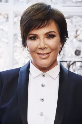 Kris Jenner in a white blouse and blue blazer