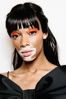 Winnie Harlow with a half-up, half-down hairstyle and blunt bangs at the John Richmond show at Milan Fashion Week in 2019
