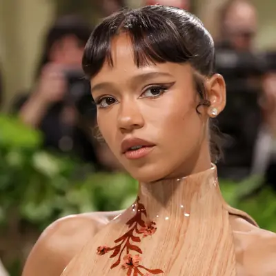 Taylor Russell with an updo and straight baby bangs at the 2024 Met Gala in New York City