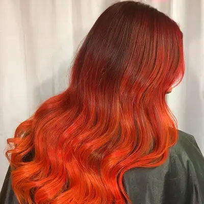 Back view of dark to bright red-orange ombre hair
