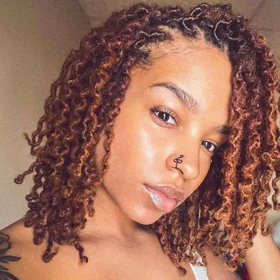 Woman with copper orange twisted natural curls