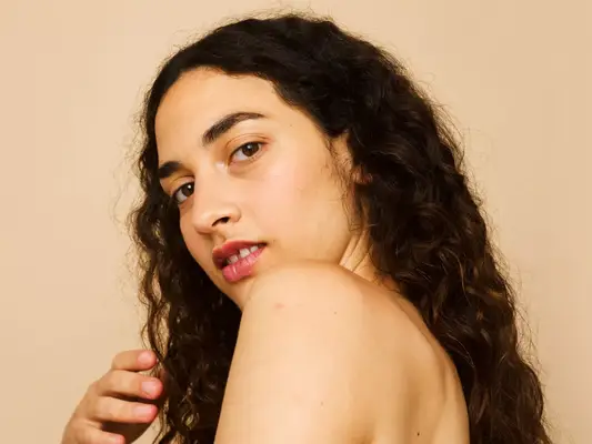 Side profile of a women with facial hair. 