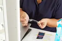 Person holding Crest 3D Whitestrips Sensitive Teeth Whitening Kit 