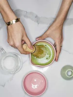 woman mixing matcha green tea
