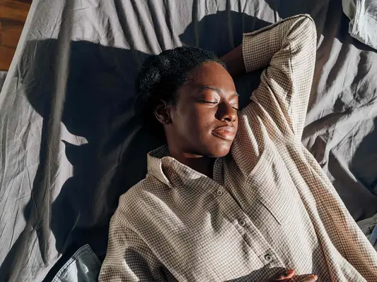 Woman sleeping in a bright room