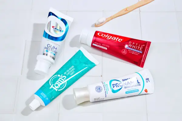 four tubes of whitening toothpaste on a bathroom counter