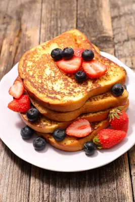 Stack of French toast with strawberries and blueberries
