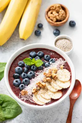 Acai bowl with blueberries, coconut flakes, walnuts, and bananas