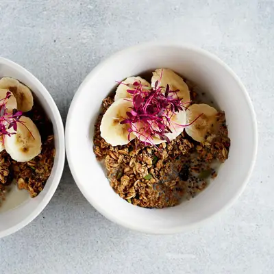bowl granola bananas and flowers