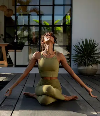 person does yoga on patio