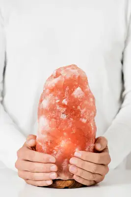 woman holding himalayan salt rock
