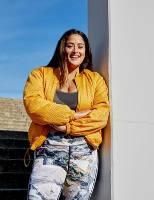 happy person leaning on a wall in the sun endomorph