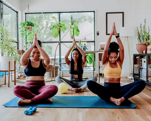 group of friends doing laughing yoga in apartment