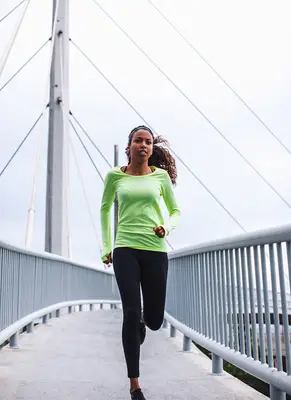 person running on bridge path