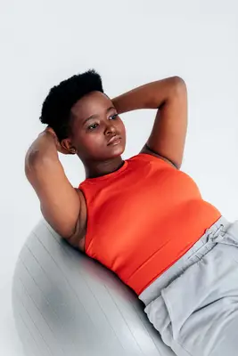 person doing pilates exercise with fitness ball