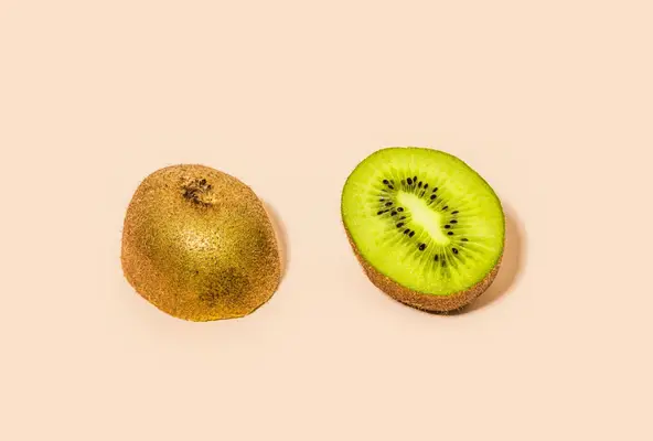 kiwi halves on light pink backdrop