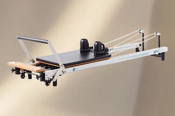 Merrithew At Home SPX Reformer Bundle against a tan background