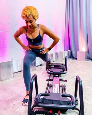 person doing lunge assisted by megaformer