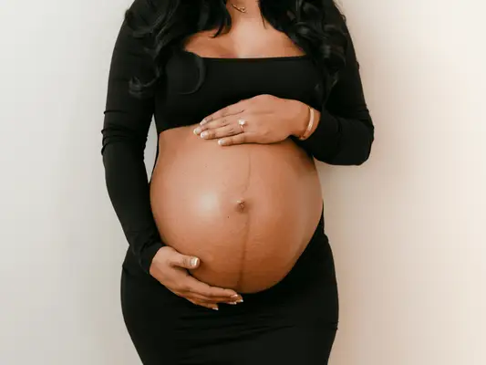 Image of a pregnant woman holding her belly