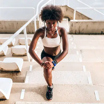 person doing lunges in stadium
