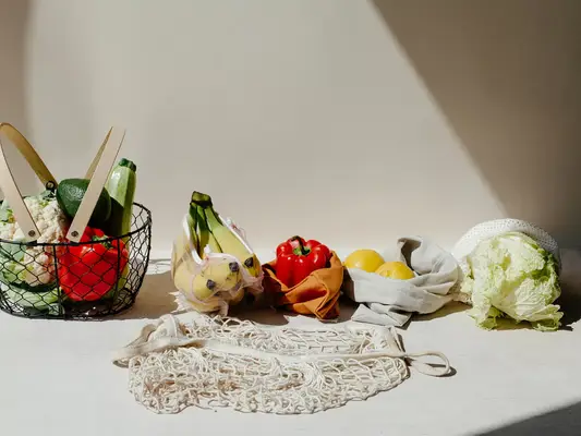 Close up of fruits and vegetables against a beige background