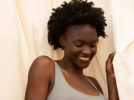 woman wearing sports bra in sheets