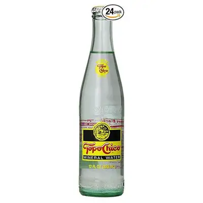 A glass bottle of Topo Chico mineral water.