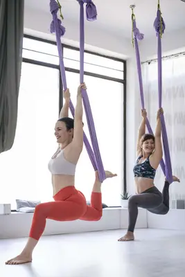 women in aerial yoga class