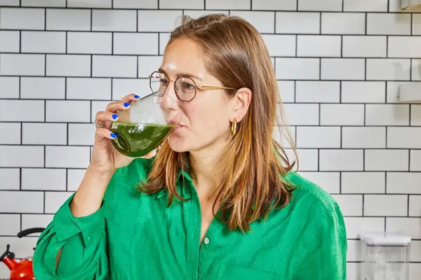 Person drinking the Ora Organic Easy Being Green Superfood Greens Powder