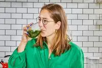 Person drinking the Ora Organic Easy Being Green Superfood Greens Powder