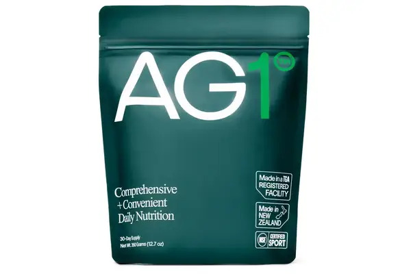 Woman pours Sakara Organic Protein + Greens Super Powder into a glass