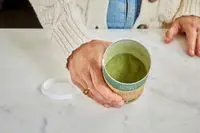 Close-up of hand holding Your Super Super Green Mix