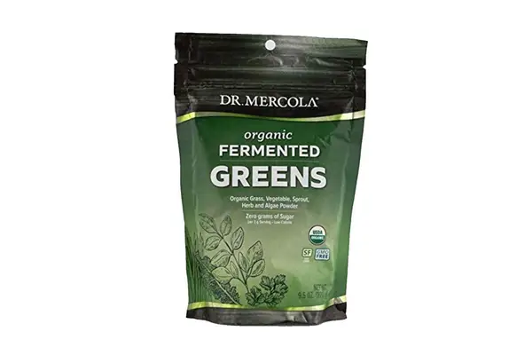 Person pouring water into a glass with AG1 by Athletic Greens