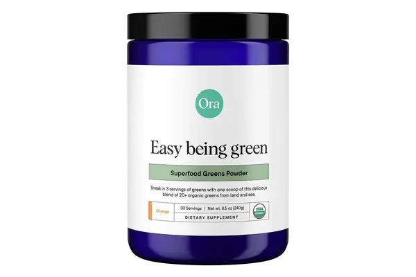 Person drinking a glass of AG1 by Athletic Greens
