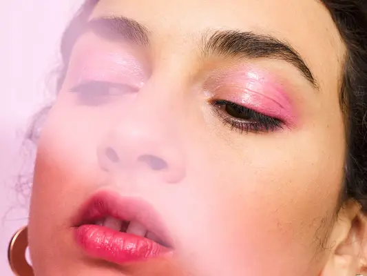 woman wearing pink eyeshadow looking to side