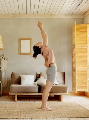 person doing sun salutation at home